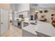 Bright kitchen featuring white cabinets, stainless steel appliances, and a large quartz countertop at 1145 Lake Rogers Cir, Oviedo, FL 32765