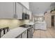 Modern kitchen with white cabinetry, stainless steel appliances, and a stylish backsplash at 1145 Lake Rogers Cir, Oviedo, FL 32765