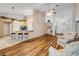 Open-concept living area featuring hardwood floors and a breakfast bar with seating at 1145 Lake Rogers Cir, Oviedo, FL 32765