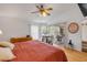 Bright primary bedroom features white walls, wood floors, ceiling fan, and slider access to the outside at 1145 Lake Rogers Cir, Oviedo, FL 32765