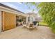 Outdoor patio with umbrella covered table, chairs, and a grill at 1145 Lake Rogers Cir, Oviedo, FL 32765