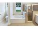 Bathroom featuring a soaking tub, separate shower and vanity at 1168 Ballyshannon Pkwy, Orlando, FL 32828