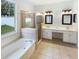 Bright bathroom with a glass enclosed shower, garden tub, and double vanity at 1168 Ballyshannon Pkwy, Orlando, FL 32828