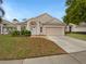 Charming single-Gathering home features a well-maintained lawn and a two-car garage at 1168 Ballyshannon Pkwy, Orlando, FL 32828