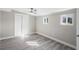 Bedroom featuring wood-look floors, gray walls and bi-fold closet door at 1203 S Pomegranite Ave, Sanford, FL 32771