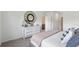 Serene main bedroom showcasing a dresser, patterned mirror, and cozy bedding at 1214 Alstonia Ln, Mount Dora, FL 32757