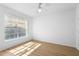 Bedroom with a large window and wood-look flooring is bright and airy at 13037 Mulberry Park Dr # 529, Orlando, FL 32821