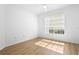 Bright bedroom with large window and light-colored walls and flooring at 13037 Mulberry Park Dr # 529, Orlando, FL 32821