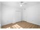 Bright bedroom features wood-look floors, a ceiling fan, closet and white walls at 13037 Mulberry Park Dr # 529, Orlando, FL 32821