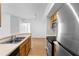 Kitchen showcasing wooden cabinets, and view into the adjacent living area at 13037 Mulberry Park Dr # 529, Orlando, FL 32821