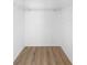 Walk-in closet has built-in shelving and wood-look flooring at 13037 Mulberry Park Dr # 529, Orlando, FL 32821