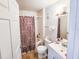 Bathroom with patterned shower curtain, white fixtures, and neutral tile flooring at 13037 Mulberry Park Drive Dr # 529, Orlando, FL 32821