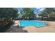 Community pool with crystal-clear water with chairs and umbrellas available for residents' enjoyment at 13037 Mulberry Park Drive Dr # 529, Orlando, FL 32821