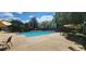 Refreshing community pool with lounge chairs and umbrellas for comfortable relaxation and leisure at 13037 Mulberry Park Drive Dr # 529, Orlando, FL 32821