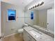 Bright bathroom features a granite countertop, large mirror, and vanity lighting at 14200 Crystal Key Pl, Orlando, FL 32824