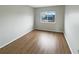 An empty bedroom with wood flooring and a window at 14200 Crystal Key Pl, Orlando, FL 32824