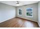 Bedroom with wood floors, ceiling fan, and natural light from two windows at 14200 Crystal Key Pl, Orlando, FL 32824