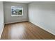 This bedroom has wood floors and a window that provides natural light and neighborhood views at 14200 Crystal Key Pl, Orlando, FL 32824