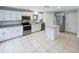 Modern kitchen with stainless steel appliances, granite countertops, and white cabinetry at 14200 Crystal Key Pl, Orlando, FL 32824