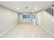 Bright and airy living room with tile flooring, recessed lighting, and seamless transition to the outdoor space at 14200 Crystal Key Pl, Orlando, FL 32824