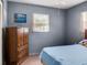 Bedroom features blue bedspread, dark blue walls and carpeted floors at 1512 N Hastings St, Orlando, FL 32808