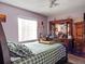 Cozy bedroom featuring a plaid comforter, wooden dresser and bright natural light at 1512 N Hastings St, Orlando, FL 32808