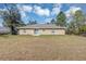 Backyard view of home featuring a sliding glass door and trees at 16121 Sw 24Th Court Rd, Ocala, FL 34473