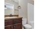 Bathroom featuring vanity with brown cabinets and a shower with a white tiled wall at 16121 Sw 24Th Court Rd, Ocala, FL 34473