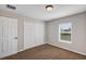 Cozy bedroom with neutral walls, carpet, window with blinds and closet with double doors at 16121 Sw 24Th Court Rd, Ocala, FL 34473