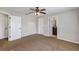 A bedroom featuring carpet and entry doors to a bathroom and hallway at 16121 Sw 24Th Court Rd, Ocala, FL 34473