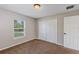 A bright bedroom featuring plush carpeting, and a closet with bi-fold doors at 16121 Sw 24Th Court Rd, Ocala, FL 34473