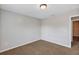 An empty bedroom featuring neutral paint, carpeting, and a bright window at 16121 Sw 24Th Court Rd, Ocala, FL 34473