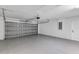 A clean garage with painted floor, garage door, and storage at 16121 Sw 24Th Court Rd, Ocala, FL 34473