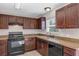 A kitchen featuring dark wood cabinets, modern appliances, and sleek countertops at 16121 Sw 24Th Court Rd, Ocala, FL 34473