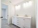 Bathroom featuring a double sink vanity, modern fixtures, and tile floors at 1802 Dixie Belle Dr, Orlando, FL 32812