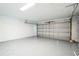 Spacious garage with an open overhead door and epoxy flooring at 1802 Dixie Belle Dr, Orlando, FL 32812