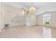 Bright foyer with tiled floors, a high ceiling, and elegant chandelier at 2422 Black Powder Ln, Kissimmee, FL 34743