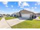 Charming single-story home featuring a well-manicured lawn and a two-car garage at 2422 Black Powder Ln, Kissimmee, FL 34743