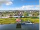 Aerial view showcasing a community clubhouse, pool, and various watercraft on the lake at 2573 Reading Trl, Kissimmee, FL 34746