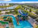 Aerial view of resort-style amenities including a large pool, lazy river, and water slides for endless fun at 2573 Reading Trl, Kissimmee, FL 34746