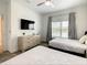 Spacious bedroom with two beds, a TV, and natural light from large windows at 2573 Reading Trl, Kissimmee, FL 34746