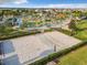 Aerial view of sand volleyball court and resort-style pool with lazy river and splash pad in a Gathering-friendly community at 2573 Reading Trl, Kissimmee, FL 34746