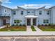 Contemporary townhome exterior with covered entrance, manicured landscaping, and clearly marked unit numbers at 2573 Reading Trl, Kissimmee, FL 34746