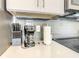 Close-up of a kitchen counter featuring a knife block, coffee maker, outlets and backsplash at 2573 Reading Trl, Kissimmee, FL 34746