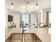 Close-up of a stainless steel, undermounted kitchen sink and faucet with a view to the living room at 2573 Reading Trl, Kissimmee, FL 34746