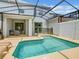 Private screened-in pool area, perfect for relaxing and entertaining with an adjacent covered patio at 2573 Reading Trl, Kissimmee, FL 34746