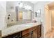 Elegant bathroom with granite countertops, a framed mirror, and decorative lighting at 2805 Grassmere Ln, Orlando, FL 32808