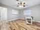 An empty bedroom featuring wood floors, neutral walls, a ceiling fan, and a whiteboard at 2805 Grassmere Ln, Orlando, FL 32808