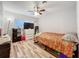 Cozy bedroom with hardwood floors, ceiling fan, and natural light from the window at 2805 Grassmere Ln, Orlando, FL 32808