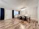 Well-lit dining room with a contemporary light fixture, hardwood floors, and stylish decor at 2805 Grassmere Ln, Orlando, FL 32808